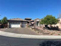 Charming single-story home featuring a two-car garage, landscaped front yard, and tiled roof at 2809 Proust Ct, Henderson, NV 89044