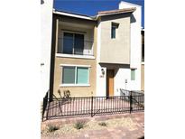 Charming two-story townhome with a welcoming front porch and balcony, perfect for enjoying the neighborhood views at 2813 Riverside Gold Ct, North Las Vegas, NV 89086