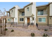 Inviting townhome with individual patios and desert landscaping in a well-maintained community at 2813 Riverside Gold Ct, North Las Vegas, NV 89086