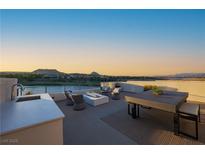 Modern rooftop deck featuring stylish seating, an outdoor kitchen, and scenic lake views at 42 Lakefront Dr, Henderson, NV 89011
