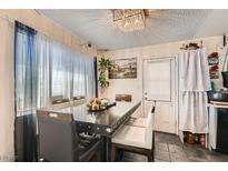 This dining area has a large table and a unique chandelier, perfect for Gathering meals at 4944 Rita Dr, Las Vegas, NV 89121