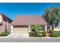 Charming single-story home featuring a two-car garage, landscaped yard, and a tile roof at 5350 Tulip Hill Ave, Las Vegas, NV 89141