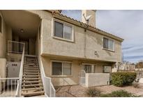 Inviting condo exterior with stucco facade, tiled roof, and convenient stair access at 661 Anne Ln # 12F, Henderson, NV 89015