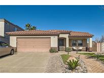 Charming single-story home featuring a two-car garage, desert landscaping, and a quaint front porch seating area at 720 Camino La Paz, Henderson, NV 89012