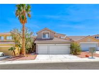 Charming two-story home featuring a two-car garage and landscaped front yard with a mature palm tree at 9505 Belgate Ct, Las Vegas, NV 89129