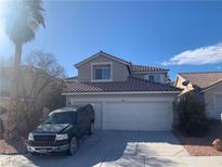 Charming two-story home featuring a three-car garage, tiled roof, and mature landscaping at 9505 Belgate Ct, Las Vegas, NV 89129
