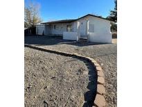 View of the home featuring a gravel yard, brick border, and partial view of the front facade at 4508 W San Miguel Ave, North Las Vegas, NV 89032