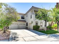 Charming two-story home with a three-car garage and well-manicured lawn at 52 Cascade Lake St, Las Vegas, NV 89148