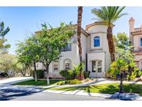 Charming two-story home with a stucco exterior, barrel tile roof, and lush desert landscaping at 52 Cascade Lake St, Las Vegas, NV 89148