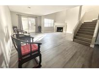 Spacious living room featuring hardwood floors, a fireplace, and a sliding glass door to the outside at 6250 W Flamingo Rd # 103, Las Vegas, NV 89103