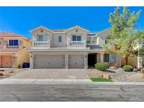 Charming two-story stucco home with a three-car garage and a well-manicured front yard at 8453 Moondance Cellars Ct, Las Vegas, NV 89139