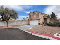 Two-story home featuring a two-car garage, desert landscaping, and a neutral stucco exterior at 1091 Dove Eagle Ct, Las Vegas, NV 89183