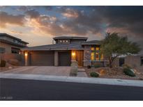 Beautiful single-Gathering home featuring manicured landscaping, a three-car garage, and stone accents at 12310 Tudor Arch Dr, Las Vegas, NV 89138