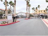 Gated community entrance with palm trees and a well-maintained landscape at 2615 W Gary Ave # 1041, Las Vegas, NV 89123