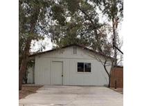 Modest home exterior with a simple design and mature trees at 4341 San Mateo St, North Las Vegas, NV 89032