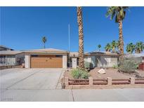 Charming single-story home featuring a desert-style front yard with mature palm trees at 4850 La Fonda Dr, Las Vegas, NV 89121