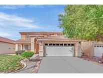 Inviting two-story home with a well-manicured lawn, spacious driveway, and attached two-car garage at 4900 Whisper Lake Ave, Las Vegas, NV 89131