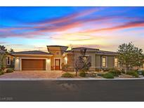 Stunning single-story home with a beautiful desert landscape and a paver driveway at 50 Carolina Cherry Dr, Las Vegas, NV 89141