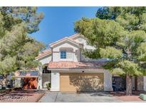 Charming two-story home featuring a well-manicured front yard and attached two-car garage, perfect for Gathering living at 5636 Royal Castle Ln, Las Vegas, NV 89130