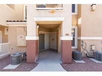 Inviting townhome entrance with covered walkway and neutral color scheme at 5855 Valley Dr # 1107, North Las Vegas, NV 89031