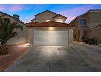 Two-story home boasts a two-car garage and a well-maintained driveway at 6328 Brianna Peak Ct, Las Vegas, NV 89142