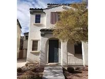Inviting two-story home featuring an arched entryway and desert landscaping at 6541 Chinatown St, Las Vegas, NV 89166