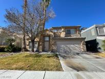 Inviting two-story home with desert landscaping and a two-car garage on a sunny day at 7213 Buglehorn St, Las Vegas, NV 89131