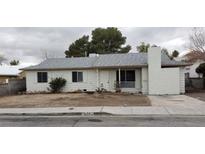 Charming single-story home featuring a low pitched roof, small windows, and stucco chimney at 834 Benita Pl, Boulder City, NV 89005
