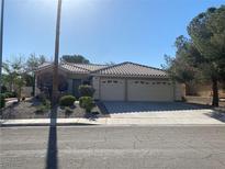 Charming single-story home featuring a tile roof, well-maintained landscaping, and a spacious three-car garage at 9014 Sierra Palms Way, Henderson, NV 89074