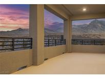 Open balcony showcasing mountain views, metal railings, and neutral color palette at 12453 Foxtail Run Ave, Las Vegas, NV 89138