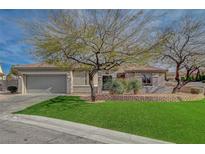 Charming single-story home featuring a well-manicured lawn, desert landscaping, and a two-car garage at 2602 Evening Sky Dr, Henderson, NV 89052