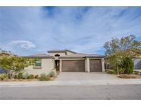 Charming single-story home featuring a three-car garage and desert landscaping at 324 S Lisbon St, Henderson, NV 89015