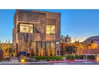 Modern two-story home features a textured facade, manicured landscaping and contemporary architectural design at 4077 Heron Fairway Dr, Las Vegas, NV 89141