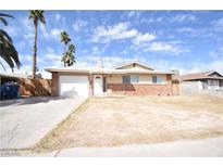 Charming single-story home featuring brick accents, desert landscaping and a two-car garage at 5087 Orinda Ave, Las Vegas, NV 89120