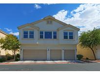 Two-story exterior elevation featuring a three-car garage and well-maintained landscaping at 5457 Jackpot Winner Ln # 101, Las Vegas, NV 89122