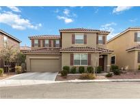 Charming two-story home featuring a tile roof, two car garage and landscaped front yard at 5967 Grechetto Ct, Las Vegas, NV 89141