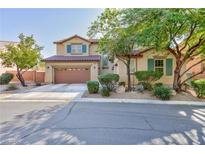 Charming two-story home with a two car garage, desert landscaping and blue shutters on the upper level windows at 10288 Grizzly Forest Dr, Las Vegas, NV 89178