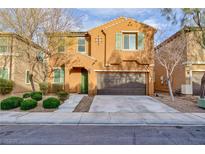 Charming two-story home features a well-manicured front yard, two-car garage, and neutral colored exterior at 10956 Hunting Hawk Rd, Las Vegas, NV 89179