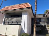 Two-story condominium featuring a balcony with railing and a traditional Spanish-style red tile roof at 1390 Vegas Valley Dr # 30, Las Vegas, NV 89169