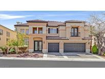 Stunning two-story home featuring a tiled roof, three-car garage, and landscaped front yard at 1401 Via Savona Dr, Henderson, NV 89052