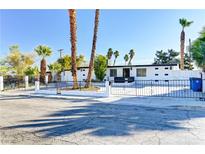 Charming single story home featuring desert landscaping and a decorative white brick and iron fence at 2754 El Toreador St, Las Vegas, NV 89169