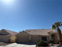 Charming single-story home featuring a terra cotta tile roof, two-car garage, and desert landscaping at 3561 Yorba Linda Dr, Las Vegas, NV 89122