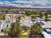 Expansive aerial view of the home with mature trees and beautiful landscaping in a desert landscape at 3710 E Oquendo Rd, Las Vegas, NV 89120