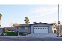Charming single-story home with a well-maintained front yard and two-car garage and driveway at 4417 Rita Dr, Las Vegas, NV 89121