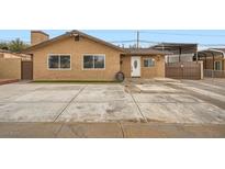 Charming single-story stucco home with large front yard and gated driveway for added privacy at 442 Republic St, Henderson, NV 89015