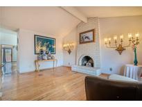 Living room featuring a fireplace, hardwood floors, and decorative lighting fixtures at 5016 Roswell St, Las Vegas, NV 89120