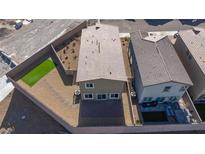 Aerial view of backyard with patio, landscaped area, and artificial turf at 5204 Sunstone Mesa Dr, Las Vegas, NV 89166