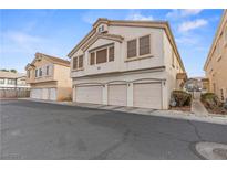 Charming townhome with three-car garage and neutral stucco exterior, offering ample parking and curb appeal at 5908 High Steed St # 102, Henderson, NV 89011