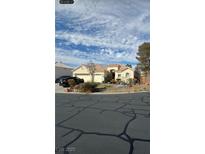 Charming single-story stucco home featuring a tile roof, two-car garage, and desert landscaping at 6664 Secluded Ave, Las Vegas, NV 89110