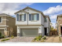 Charming two-story home featuring a neutral stucco facade, decorative shutters, and an attached two-car garage at 7061 Tilligerry St, North Las Vegas, NV 89084
